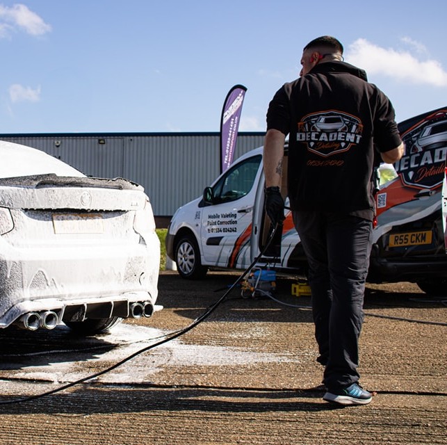 Decadent Detailing valeter pressure washing a BMW during a mobile car valet in Wellingborough